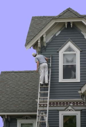 Painter working on home exterior